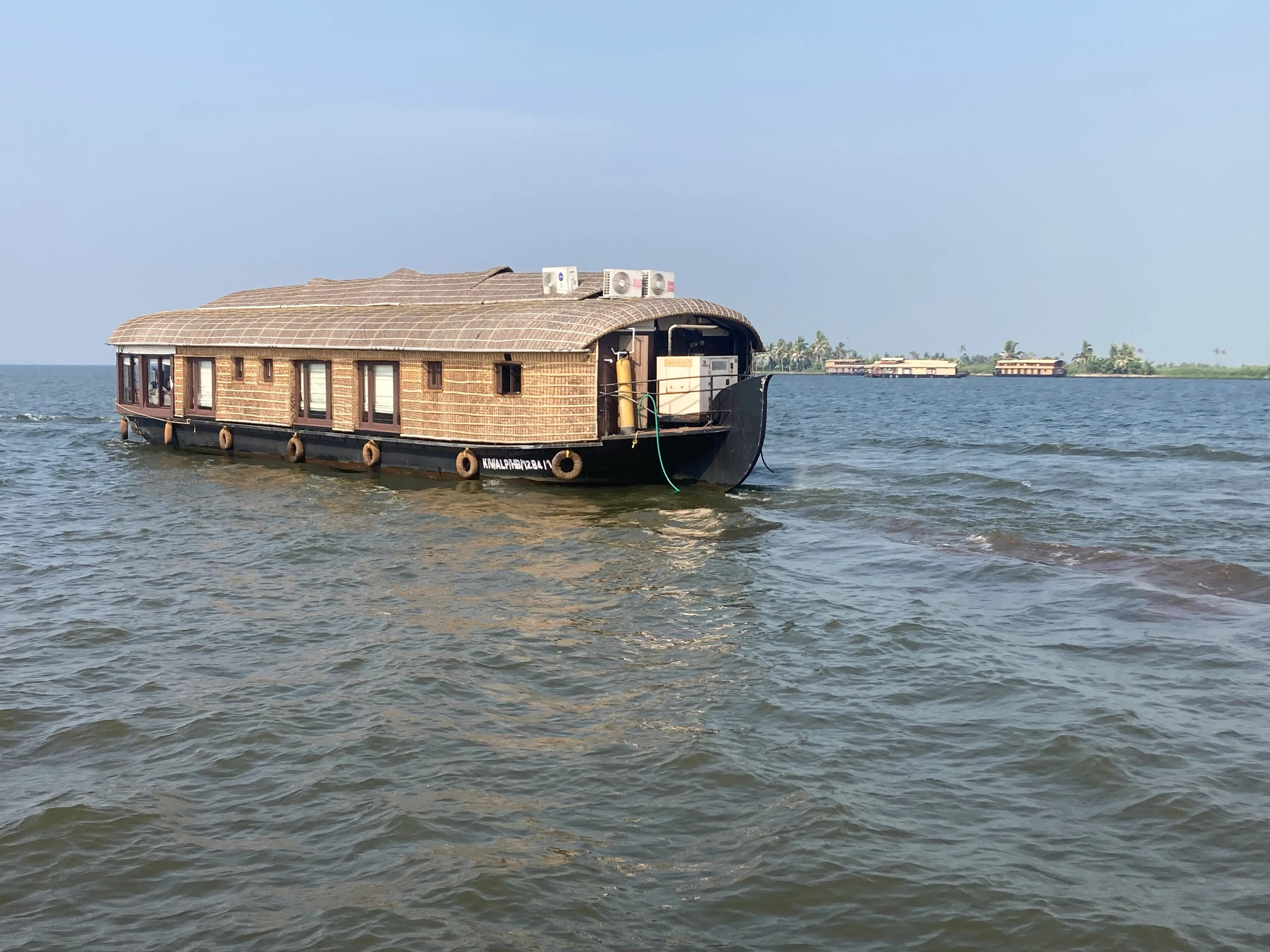 Alleppey Kerala backwater jetty at golden hour with a moored houseboat